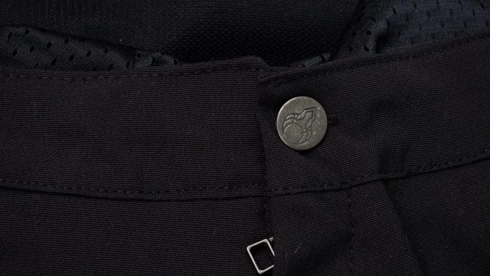 Closeup of main button after replacement with one I had on hand from other riding pants